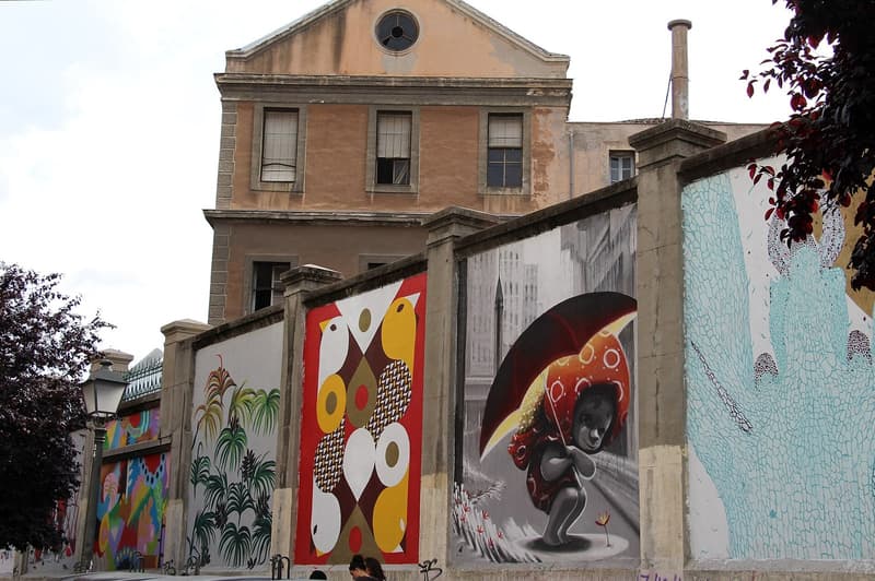 Murals along the walls of La Tabacalera