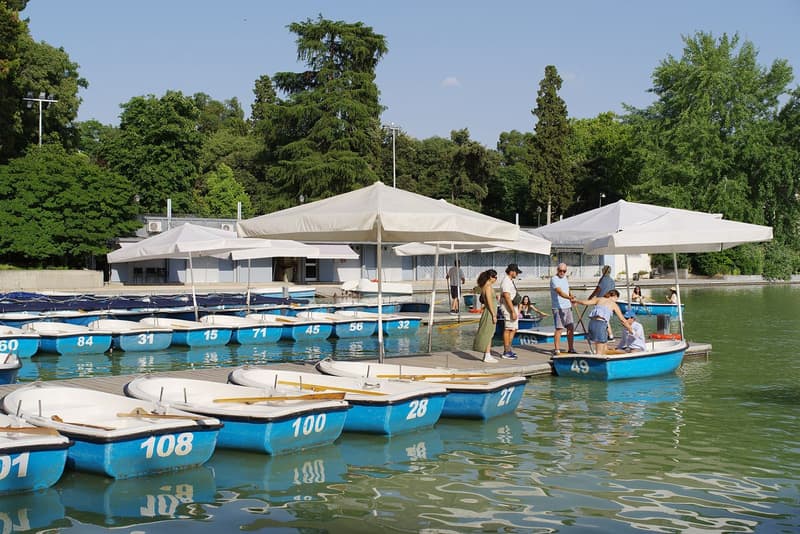 The boat landing on the Estanque lake in Madrid's Retiro park, with the Alfonso XII monument colonnade behind