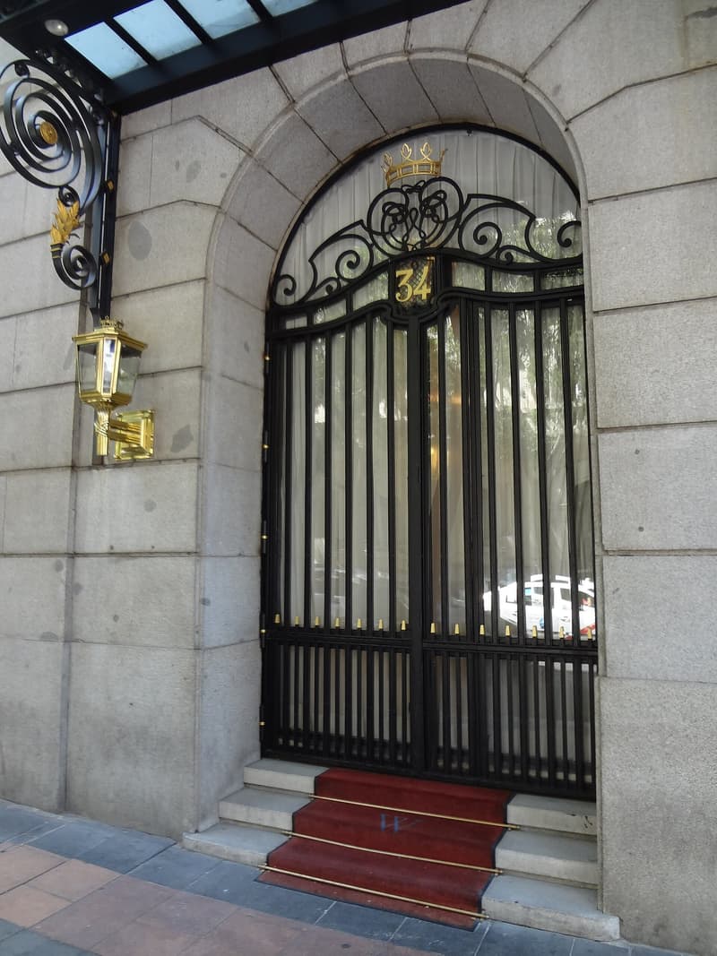 A wrought-iron doorway, red carpet included